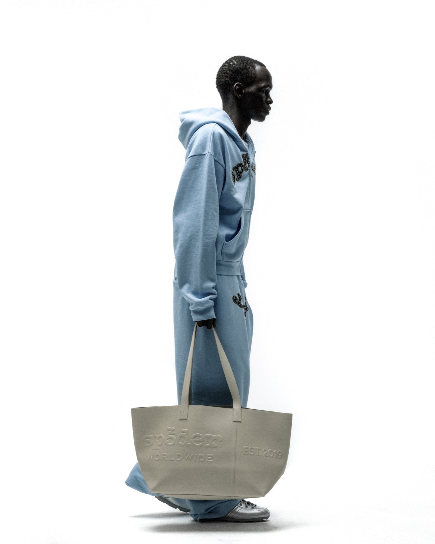 Light gray genuine leather tote bag with embossed "Spödem Worldwide" and "EST. 2019" logos.