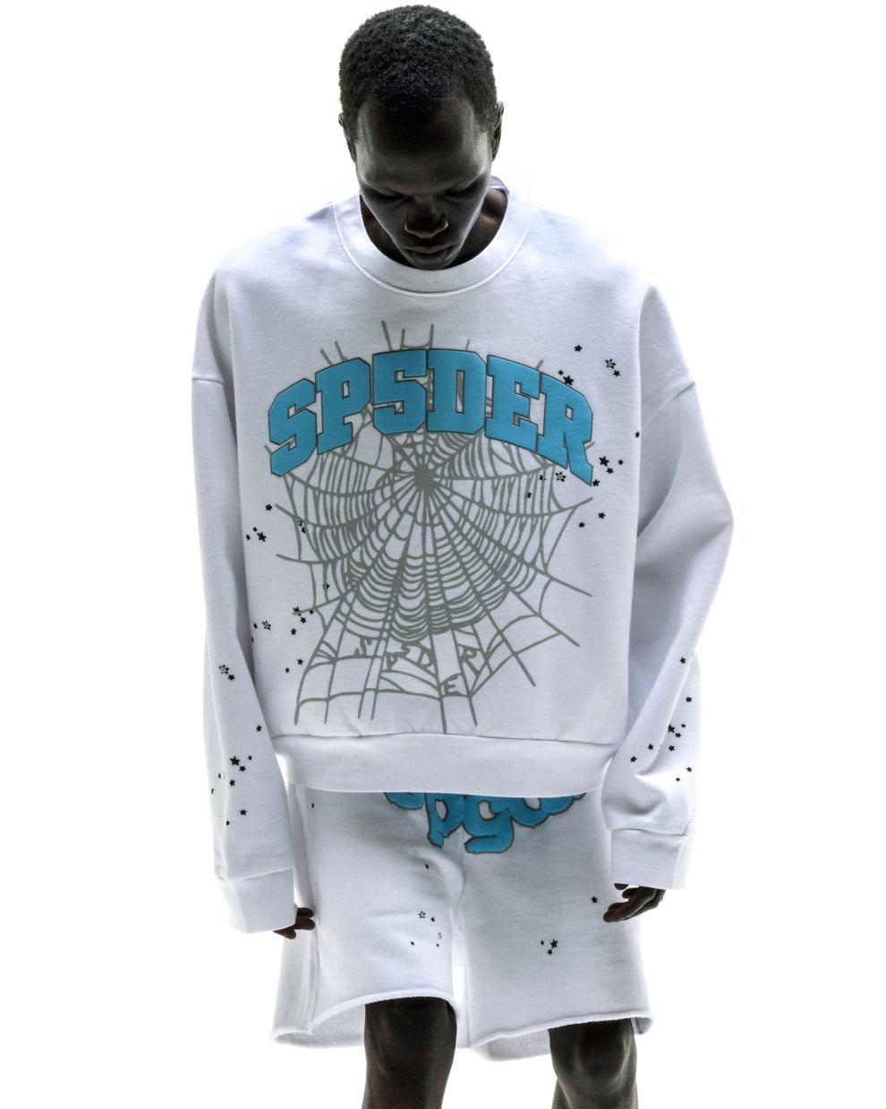 White VARSITY WEB CREWNECK with blue "SPIDER" text, grey web print, and scattered black stars.