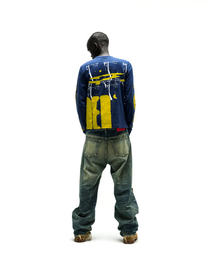 Man in a navy blue X-RAY LONGSLEEVE cotton tee with yellow graphic print on back and sleeves.