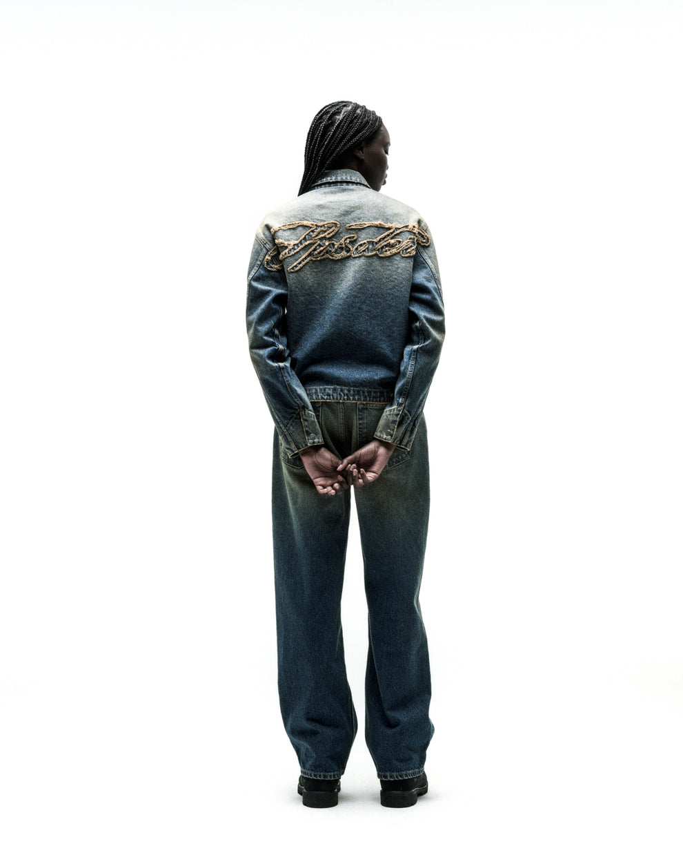 Washed blue denim work jacket with "SCRIPT" embroidery on back, paired with matching jeans.