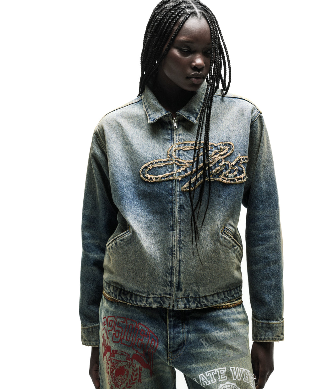 Washed blue denim work jacket with a gold chain script logo and full zipper.