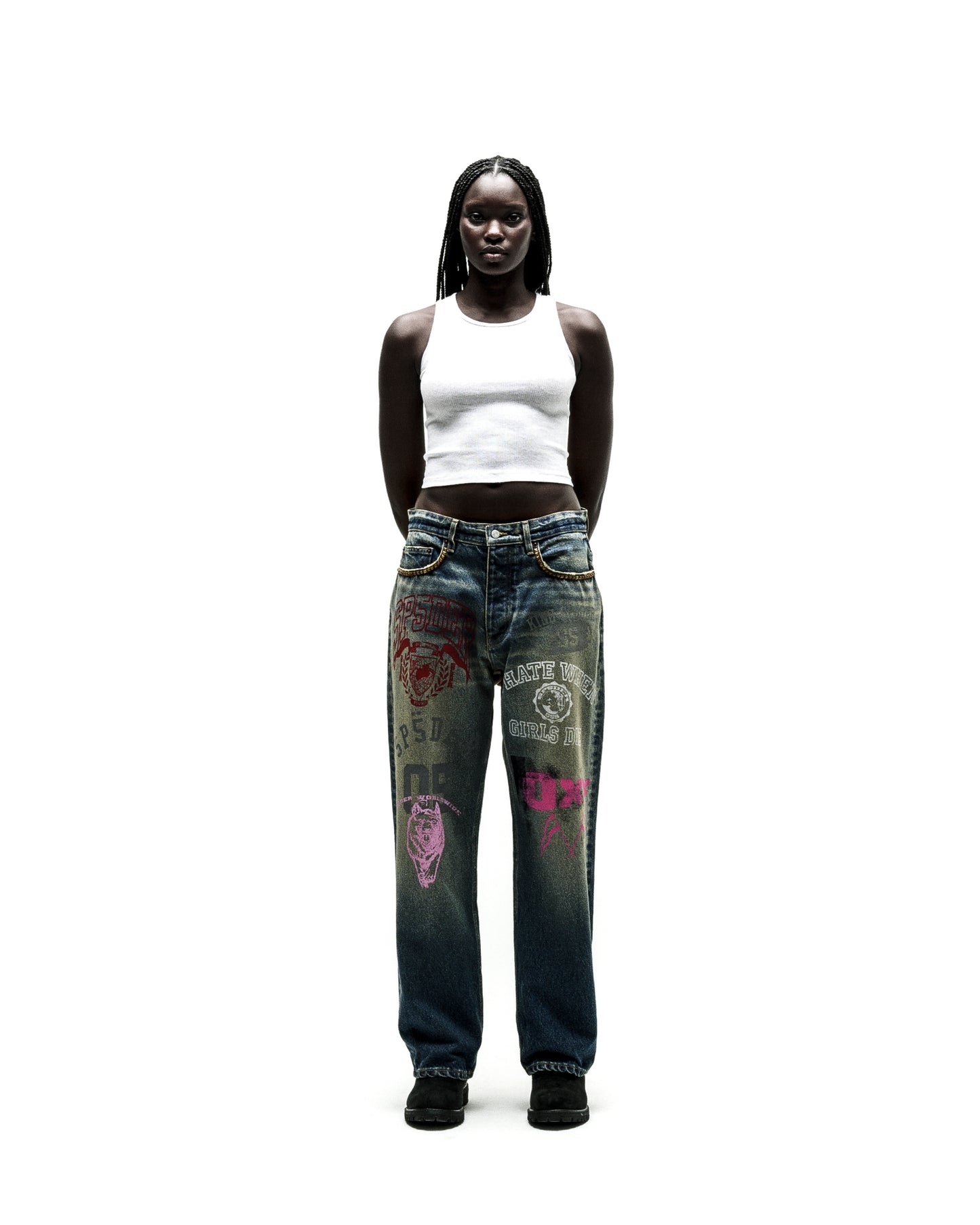Dark wash baggy jeans with colorful graphic prints and yellow chain detail on pockets.