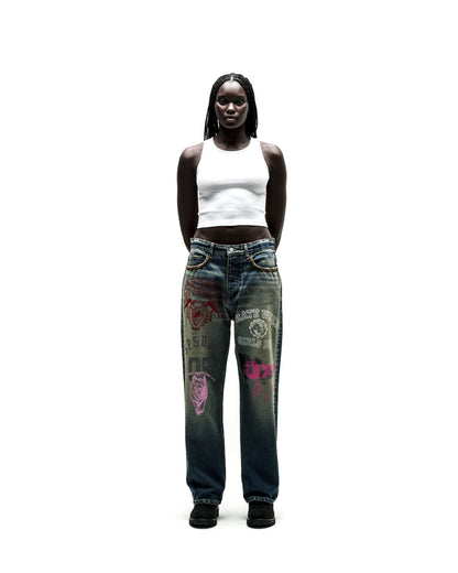 Dark wash baggy jeans with colorful graphic prints and yellow chain detail on pockets.