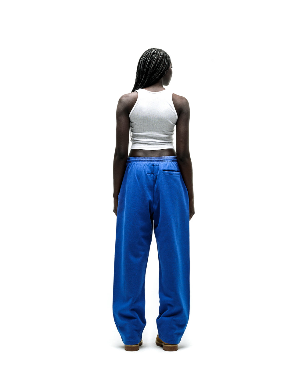 Model wearing blue RHINESTONE PUNK V2 SWEATPANTS with a wide leg and elasticized waistband.
