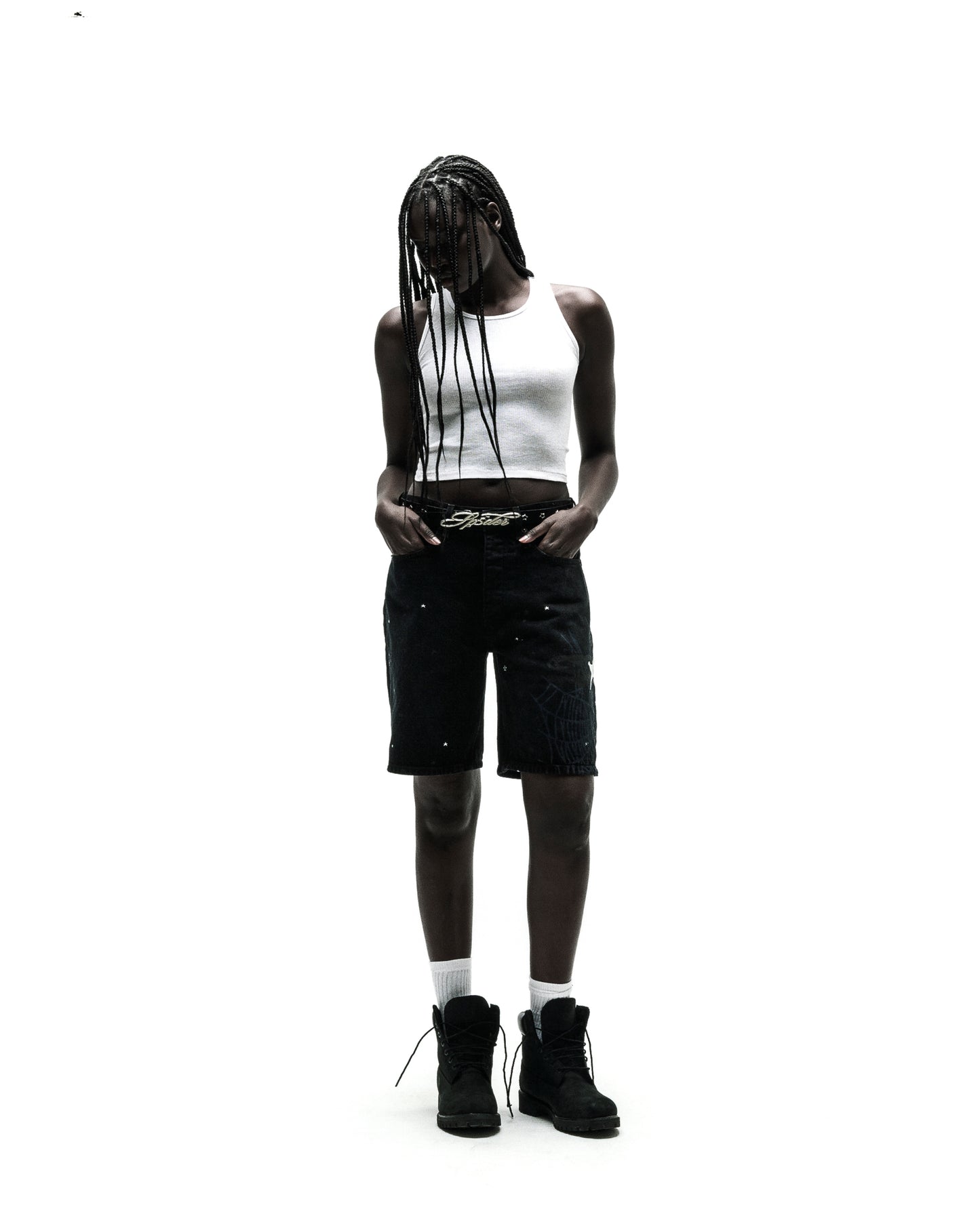 Black HEAVY WEB JEAN SHORTS with white spiderweb graphic, worn by a model with a white tank top and black boots.