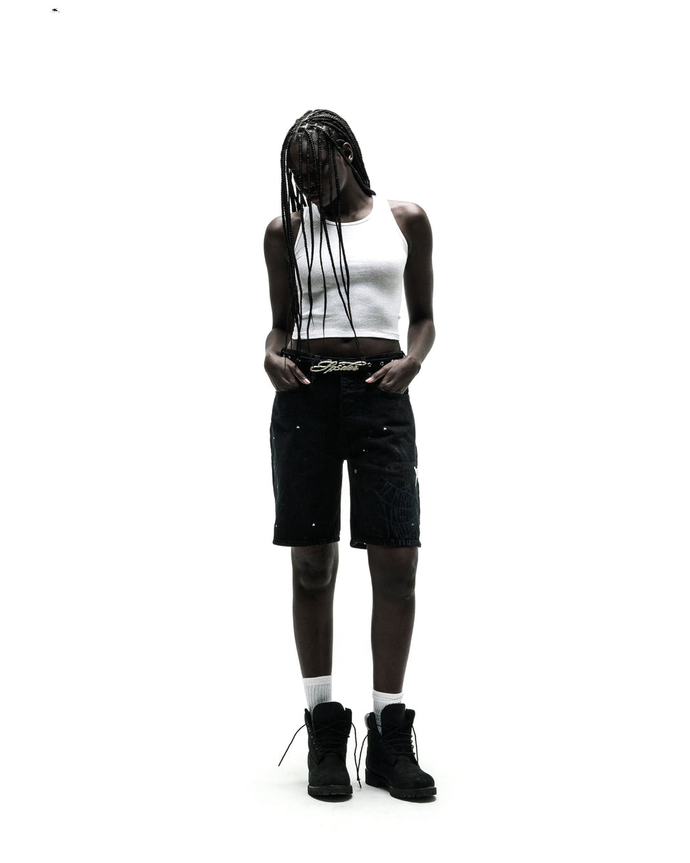 Black HEAVY WEB JEAN SHORTS with white spiderweb graphic, worn by a model with a white tank top and black boots.