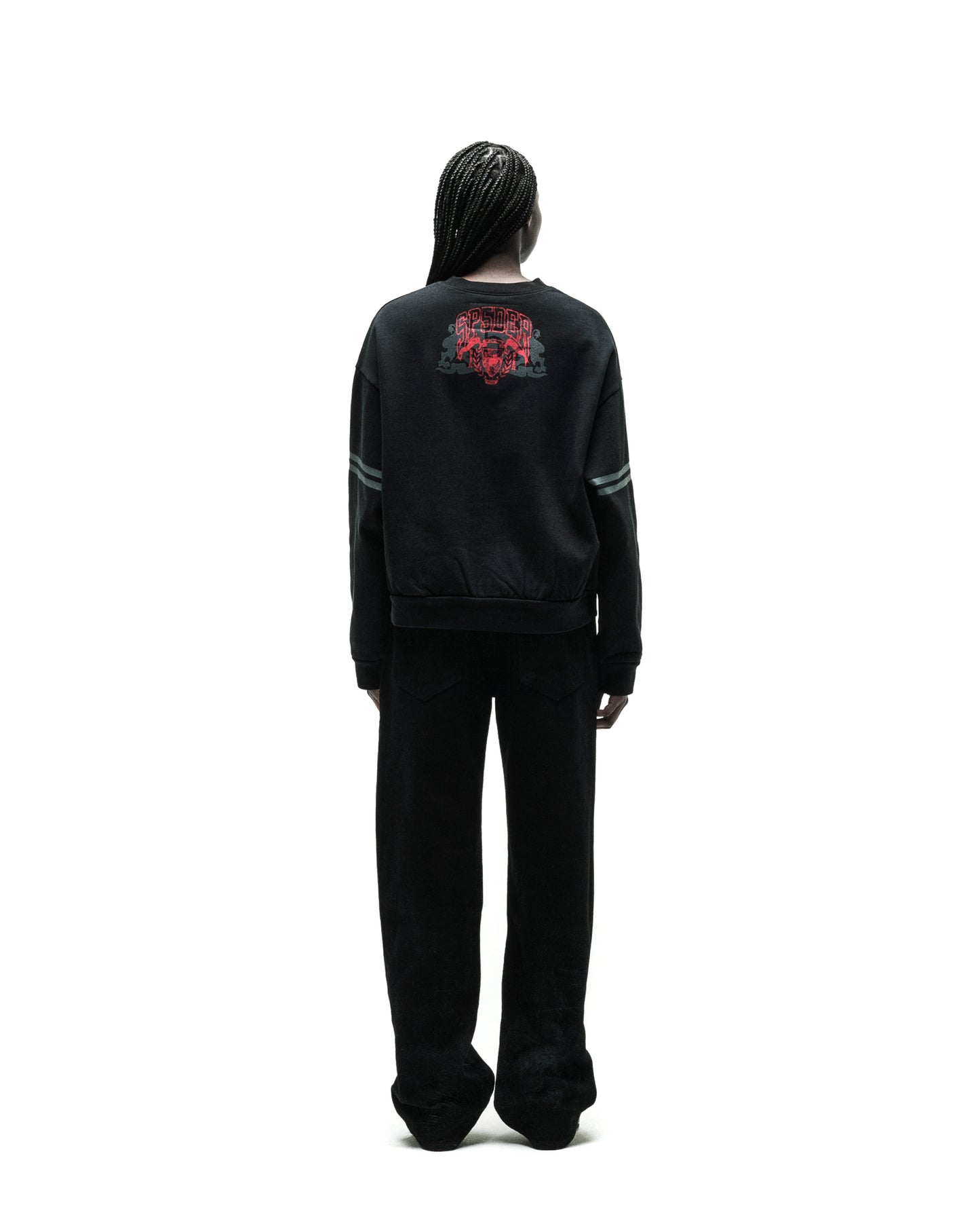 Black ARANEA CREWNECK with red spider graphic on back, grey sleeve stripes, and black wide-leg pants.