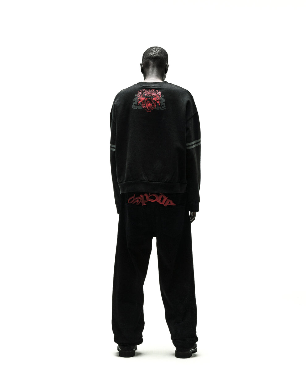 Black ARANEA CREWNECK sweatshirt with red graphic on back, paired with matching black sweatpants.