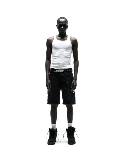 Man in black HEAVY WEB JEAN SHORTS with white web graphic, white tank top, and black boots.