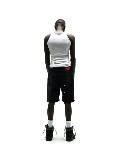 Black denim Heavy Web Jean Short with silver studs, red tag, and black boots.