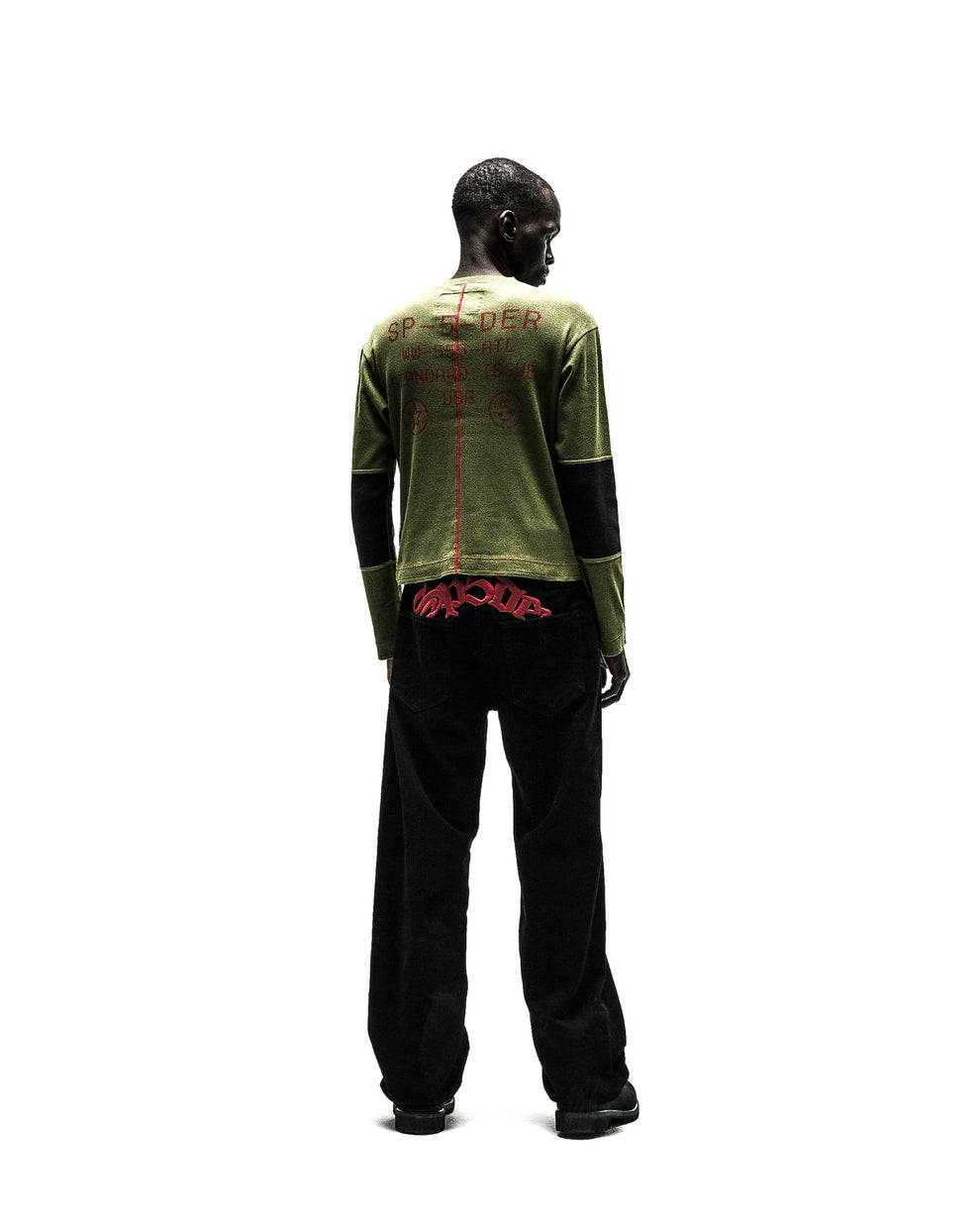SERVICE LONGSLEEVE: Olive green long-sleeve shirt with red text, black cuffs, paired with black wide-leg pants.